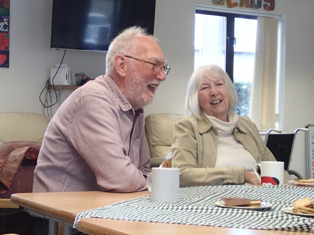 Smiling older couple eating cake