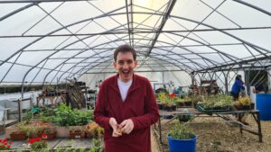 A Guideposts member smiling and having fun gardening.