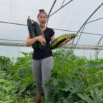 Helen smiling holding vegetables grown at Guideposts Dig N Grow group.