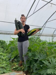 Helen smiling holding vegetables grown at Guideposts Dig N Grow group.