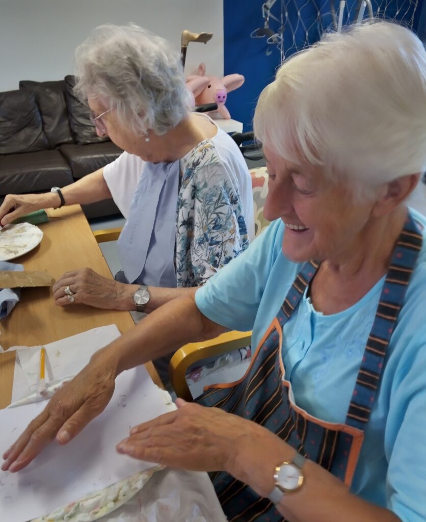 Two older ladies enjoying crafts.