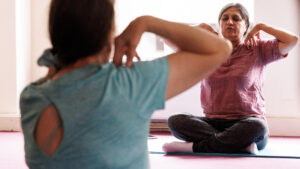 Two Guideposts members take part in yoga to improve their mental health.