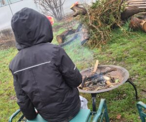 Child toasting marshmallows over Fire