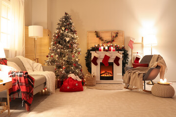 A lounge decorated for Christmas with tree, wreaths, and stockings.