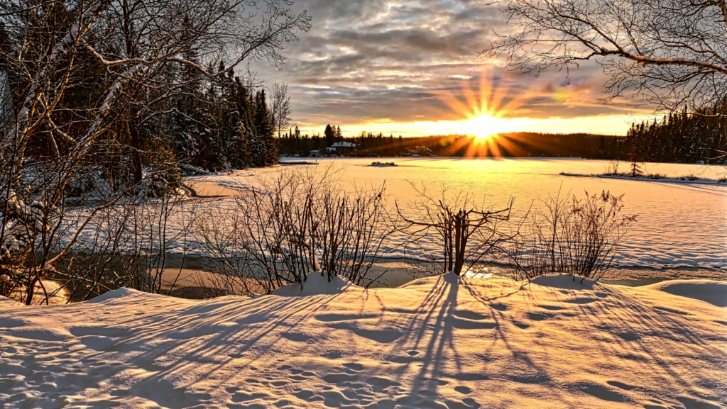 A snowy landscape at sunset.