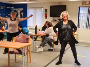 People dancing with and smiling at Guideposts group