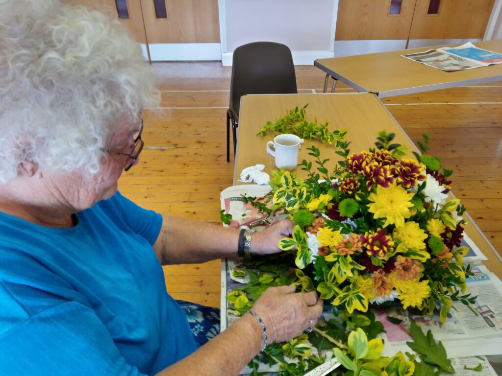 Flower arranging with bright yellow flowers at CONNECT.