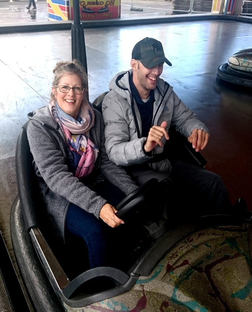 Guideposts members in dodgem carts during a friendship trip.