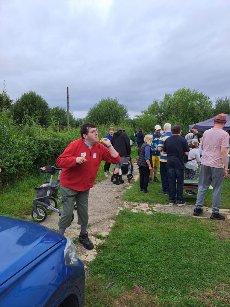 Person poised to throw a dart