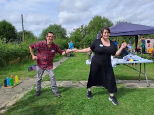 People posing, handing a baton from one to the other as if in a relay race