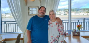 man with his arm around his mother, posing for a photo.