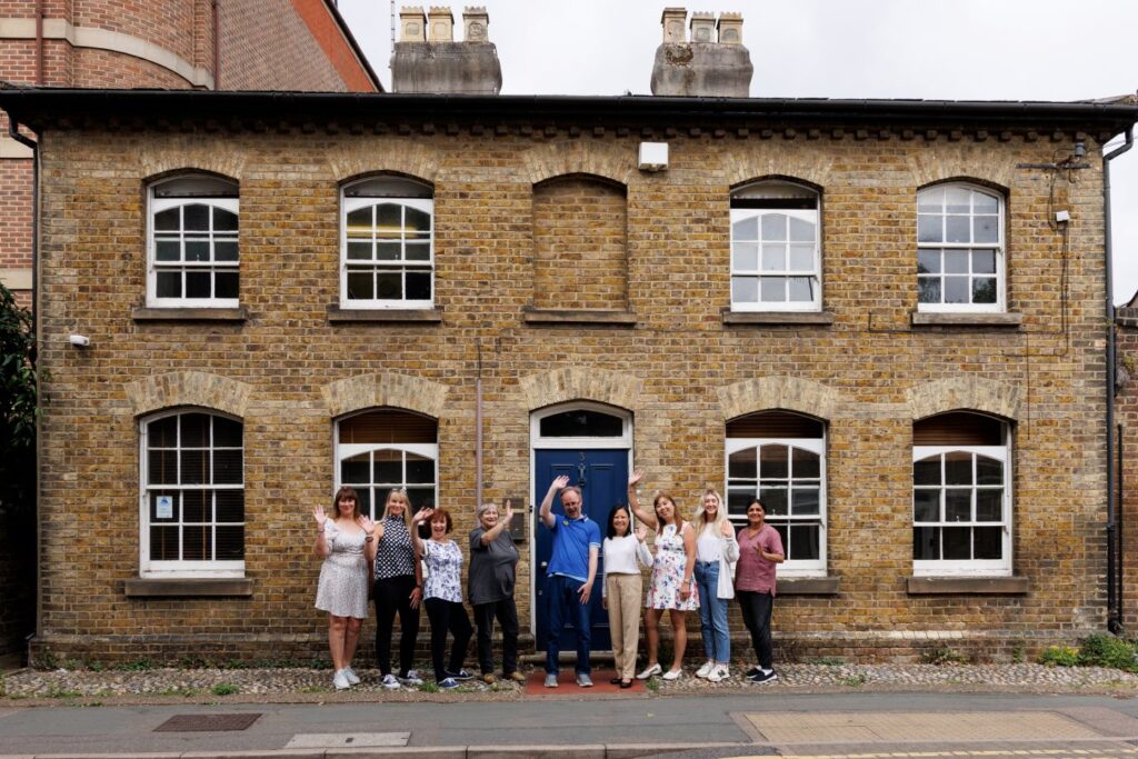 a group of people waving, outside Guideposts Hub in Watford