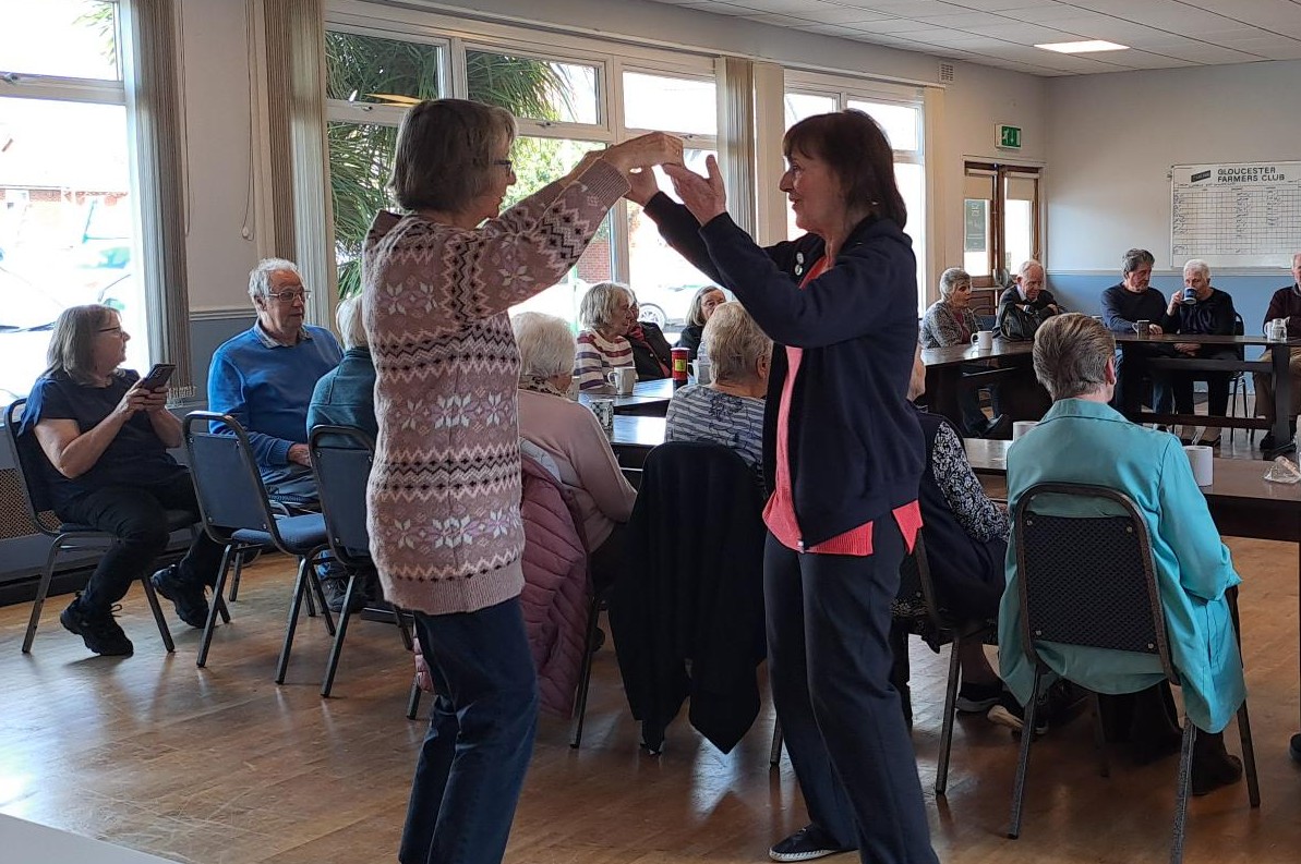 A woman dancing with a Guideposts team member as part of dementia support CONNECT group